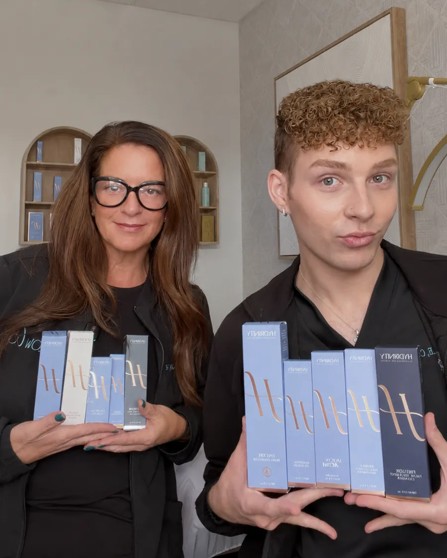 Jillian and Cruz holding the ten full-size Hydrinity products in the giveaway